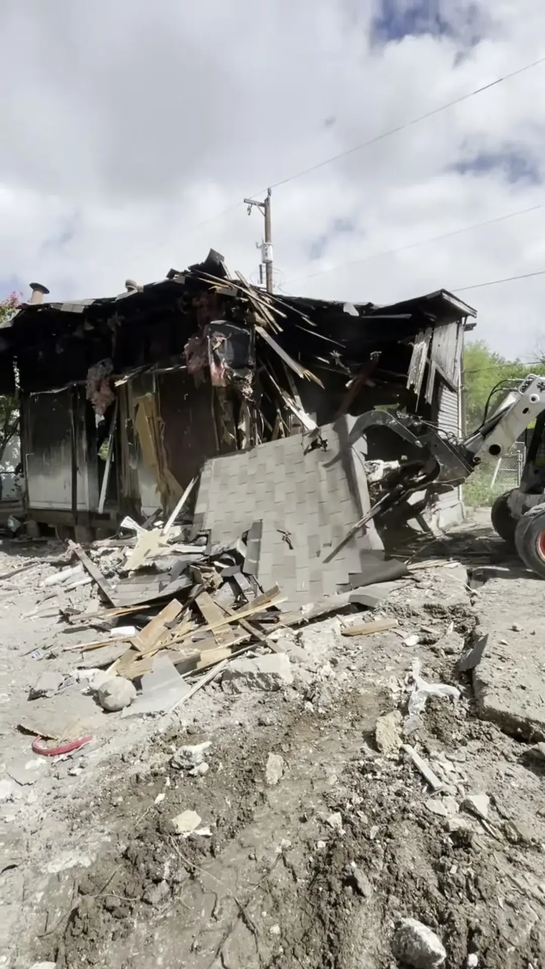 Demolition debris sorted by the Five Star Trucking skid steer during a San Antonio teardown