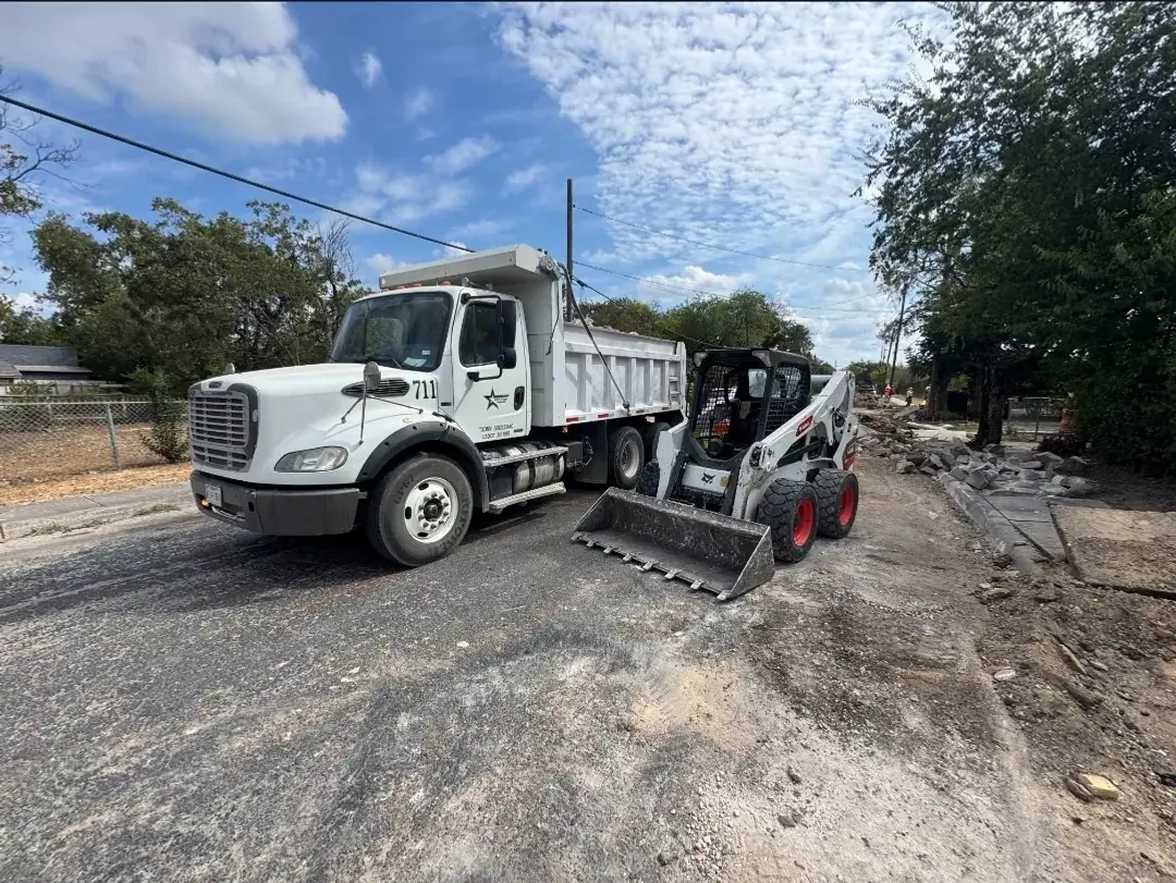 Five Star Trucking dump truck and skid steer on a San Antonio job