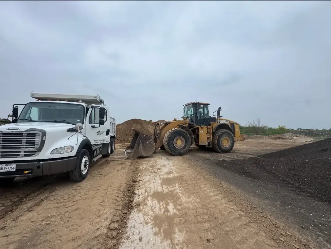 Five Star Trucking dump truck being loaded at a material yard