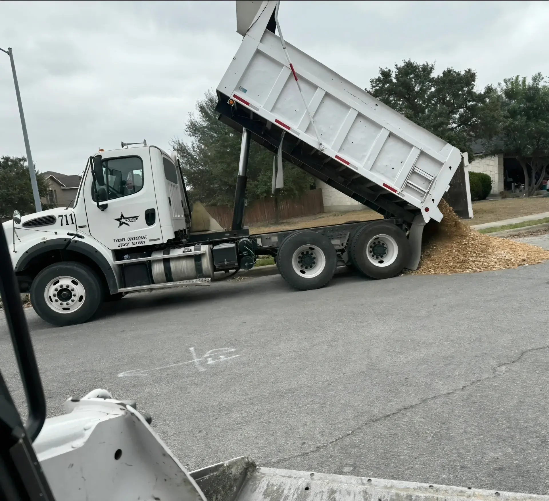 Five Star Trucking dump truck unloading a material delivery in San Antonio